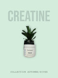 Bote de creatina monohidrato Nutriplus by Farmasi de Lilibeth Colmenarez Media junto a una planta decorativa